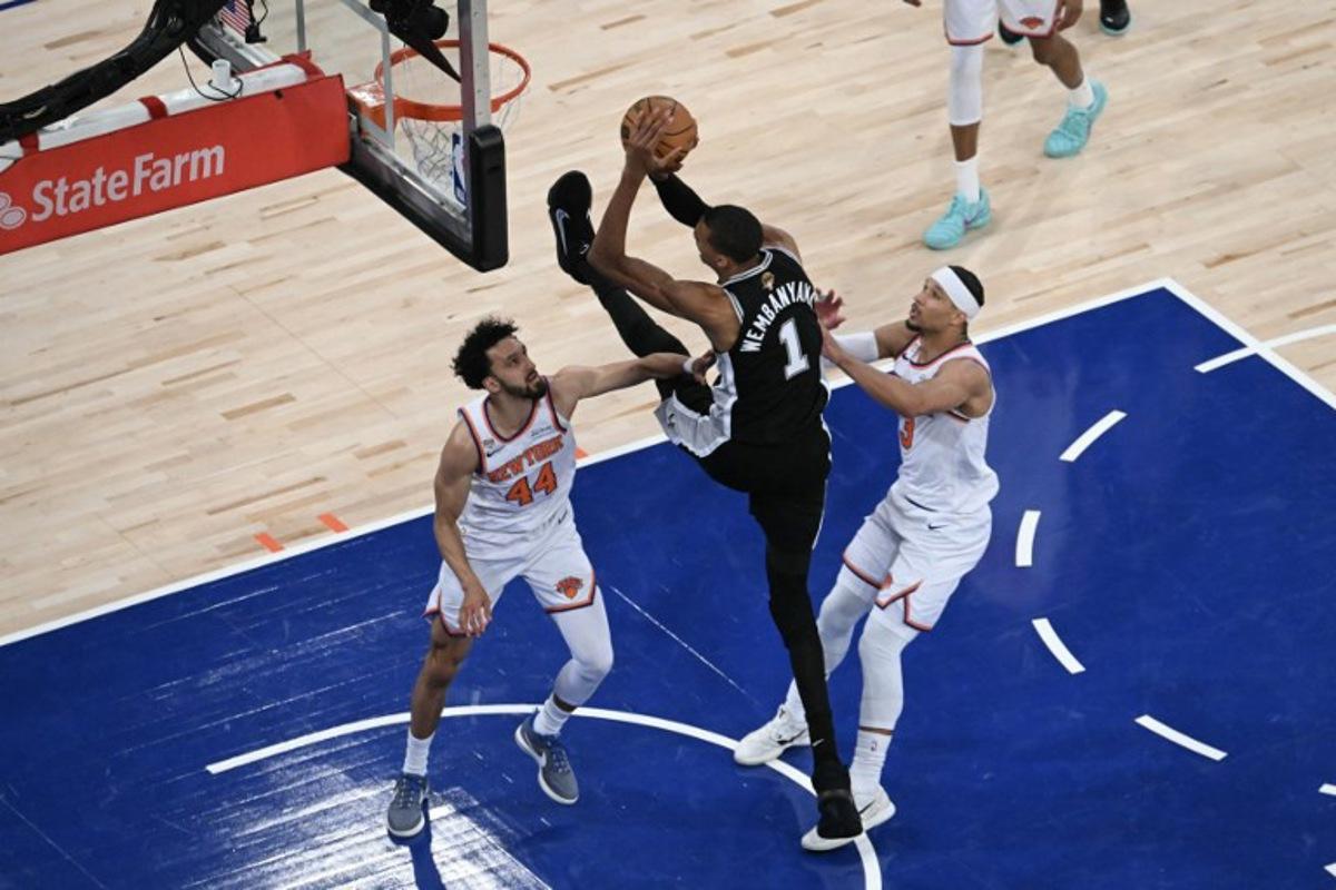 San Antonio Spurs' French forward-center #01 Victor Wembanyama shoots the ball while being defended by Knicks guard #44 Landry Shamet and Knick guard #03 Josh Hart during Game Three of the NBA Finals between the San Antonio Spurs and the New York Knicks at Madison Square Garden in New York on June 8, 2026.  SAUL LOEB / AFP