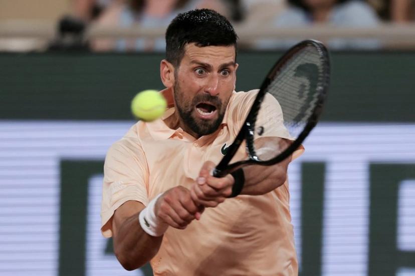 Serbia's Novak Djokovic plays a backhand return to France's Giovanni Mpetshi Perricard during their men's singles match on day 1 of the French Open tennis tournament on Court Philippe-Chatrier at the Roland-Garros Complex in Paris on May 24, 2026.  Thomas SAMSON / AFP