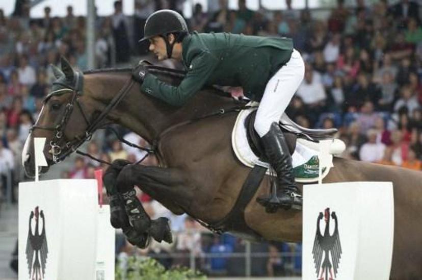 Ireland's Billy Twomey on Je t'Aime Flamenco clears an obstacle during the first round of the Jumping Nation's Cup at the World Equestrian Festival CHIO, in Aachen, on July 5, 2012. Ireland took third place. The CHIO, the last major equestrian event before the London Olympics, takes place from July 3 to 8.  AFP PHOTO / JOHN MACDOUGALL