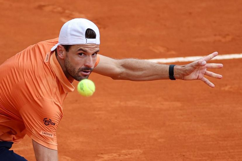 Bulgaria's Grigor Dimitrov eyes the ball as he plays against Argentina's Tomas Martin Etcheverry during the Monte Carlo ATP Masters Series Tournament round of 64 tennis match on Court des Princes at the Monte-Carlo Country Club in Roquebrune-Cap-Martin, south-eastern France on April 7, 2026.  Valery HACHE / AFP