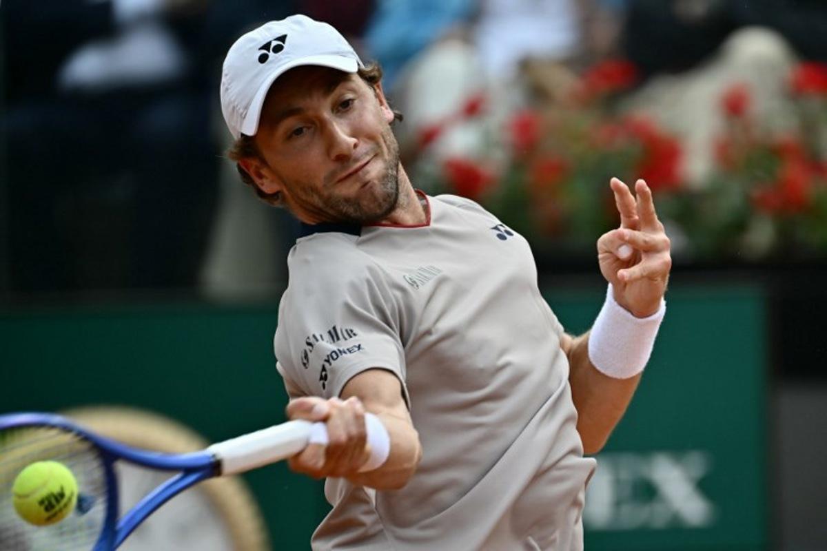 Norway's Casper Ruud hits a return to Italy's Luciano Darderi during their semi-final of the ATP Rome Open tennis tournament at Foro Italico in Rome on May 15, 2026.   Filippo MONTEFORTE / AFP
