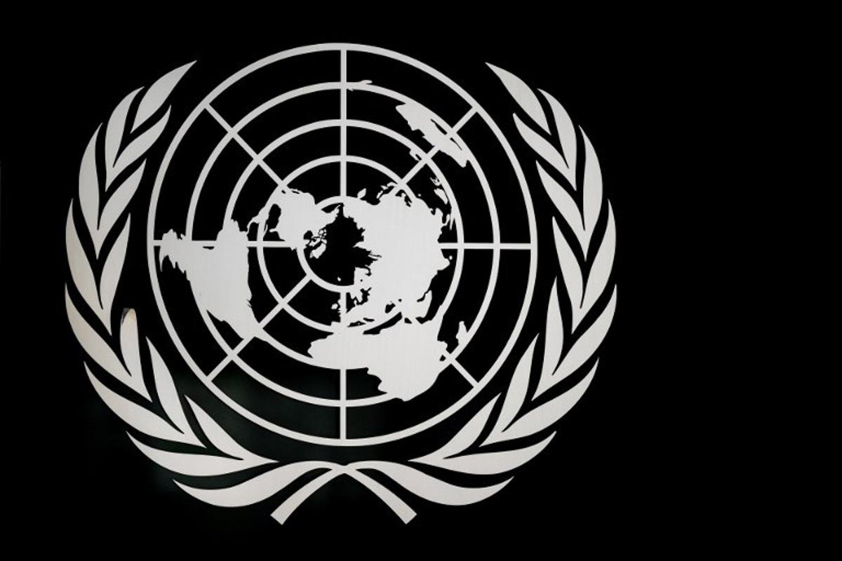 A sign of the United Nations is seen at the "Palais des Nations" building which houses the UN Offices in Geneva on March 3, 2026.   Fabrice COFFRINI / AFP