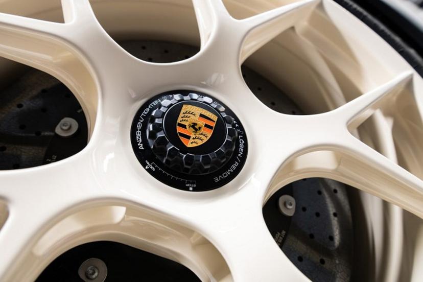 The Porsche emblem in the middle of a rim of a Porsche 911 S/T is pictured at the "Exclusive Manufaktur" of German luxury car maker Porsche, where clients can get their vehicles customized in Stuttgart - Zuffenhausen on March 6, 2025    SILAS STEIN / AFP