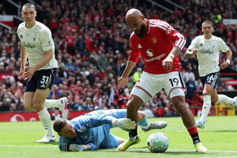 Manchester United's Cameroonian midfielder #19 Bryan Mbeumo (R) takes the ball around Nottingham Forest's Belgian goalkeeper #26 Matz Sels during the English Premier League football match between Manchester United and Nottingham Forest at Old Trafford in Manchester, north west England, on May 17, 2026.  Darren Staples / AFP