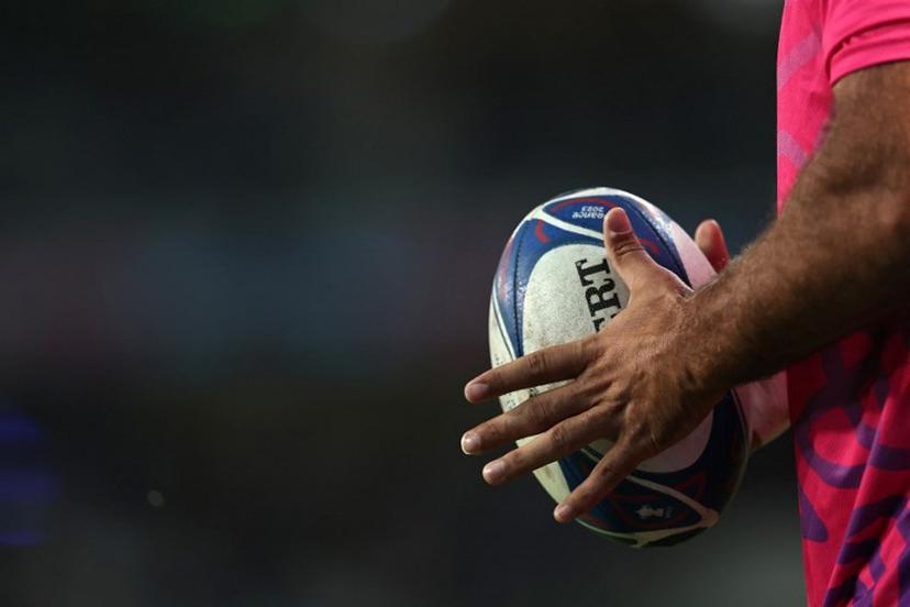 A player holds a rugby ball ahead of the France 2023 Rugby World Cup Pool B match between Scotland and Romania at Pierre-Mauroy stadium in Villeneuve-d'Ascq near Lille, northern France, on September 30, 2023.  FRANCK FIFE / AFP
