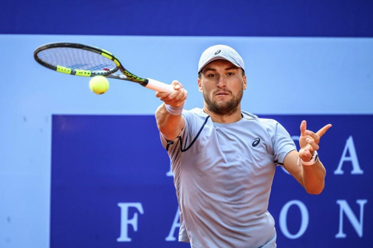 Belgium's Raphael Collignon returns the ball to Greece's Stefanos Tsitsipas during their men's singles final match at the Swiss Open tennis tournament in Gstaad, on July 19, 2026.  Fabrice COFFRINI / AFP