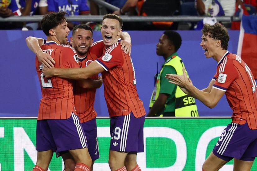 Scotland's midfielder #07 John McGinn (2nd L) celebrates with teammates after scoring his team's first goal during the 2026 World Cup Group C football match between Haiti and Scotland at the Boston Stadium in Foxborough on June 13, 2026.  FRANCK FIFE / AFP