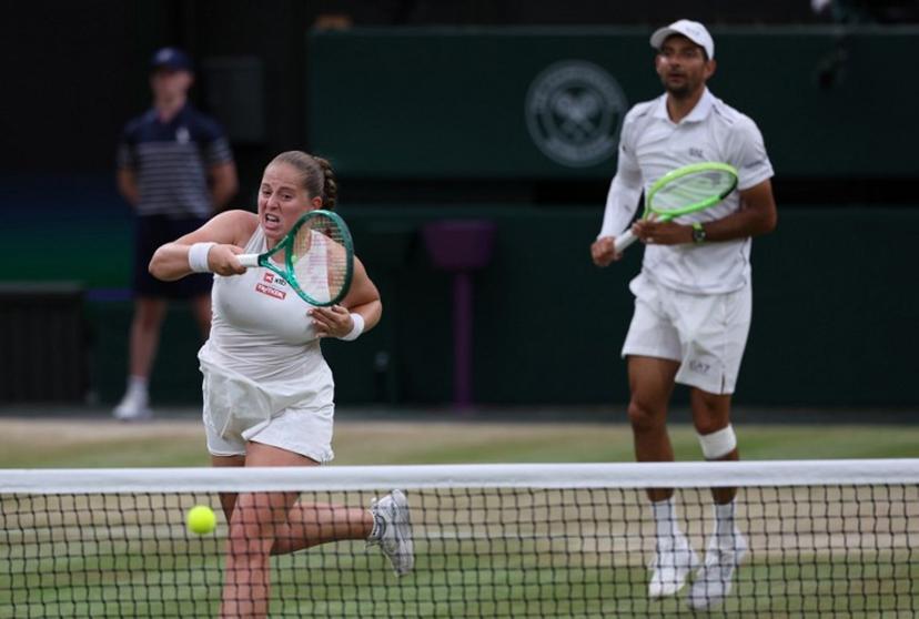 El Salvador's Marcelo Arevalo (R) and Latvia's Jelena Ostapenko play against Australia's players Marc Polmans and Storm Hunter during their mixed's doubles final tennis match on the eleventh day of the 2026 Wimbledon Championships at The All England Lawn Tennis and Croquet Club in Wimbledon, southwest London, on July 9, 2025.  Adrian Dennis / AFP