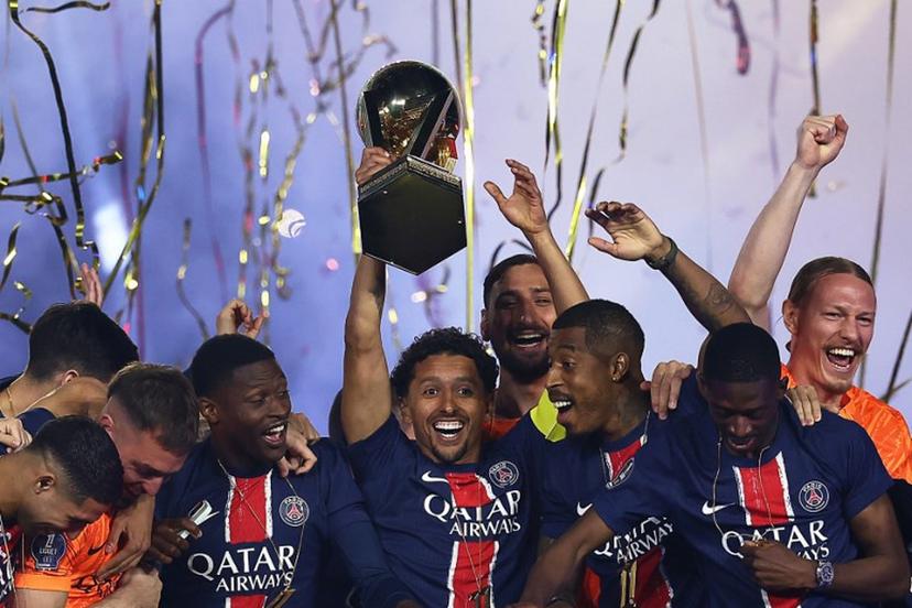 Paris Saint-Germain's Brazilian defender #05 Marquinhos (C) lifts the trophy as PSG celebrate their championship title following the French L1 football match between Paris Saint-Germain (PSG) and AJ Auxerre at The Parc des Princes Stadium in Paris on May 17, 2025.  FRANCK FIFE / AFP