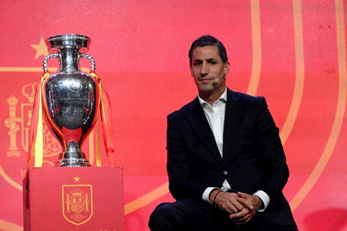 Former Spain's player Joan Capdevila poses next to Henri Delaunay cup, the trophy of the UEFA European Football Championship, during the unveiling of Euro 2024 squad on May 27, 2024 at the Ciudad del Futbol training facilities in Las Rozas de Madrid.  JAVIER SORIANO / AFP