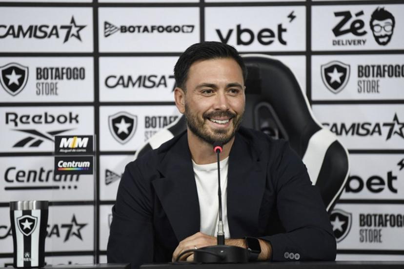 Davide Ancelotti gestures during his presentation as the new head coach of the Botafogo football club in Rio de Janeiro, Brazil on July 14, 2025. Davide, 35, is the son of Brazil's national football team head coach Carlo Ancelotti and worked with his father as assistant coach. Daniel RAMALHO / AFP