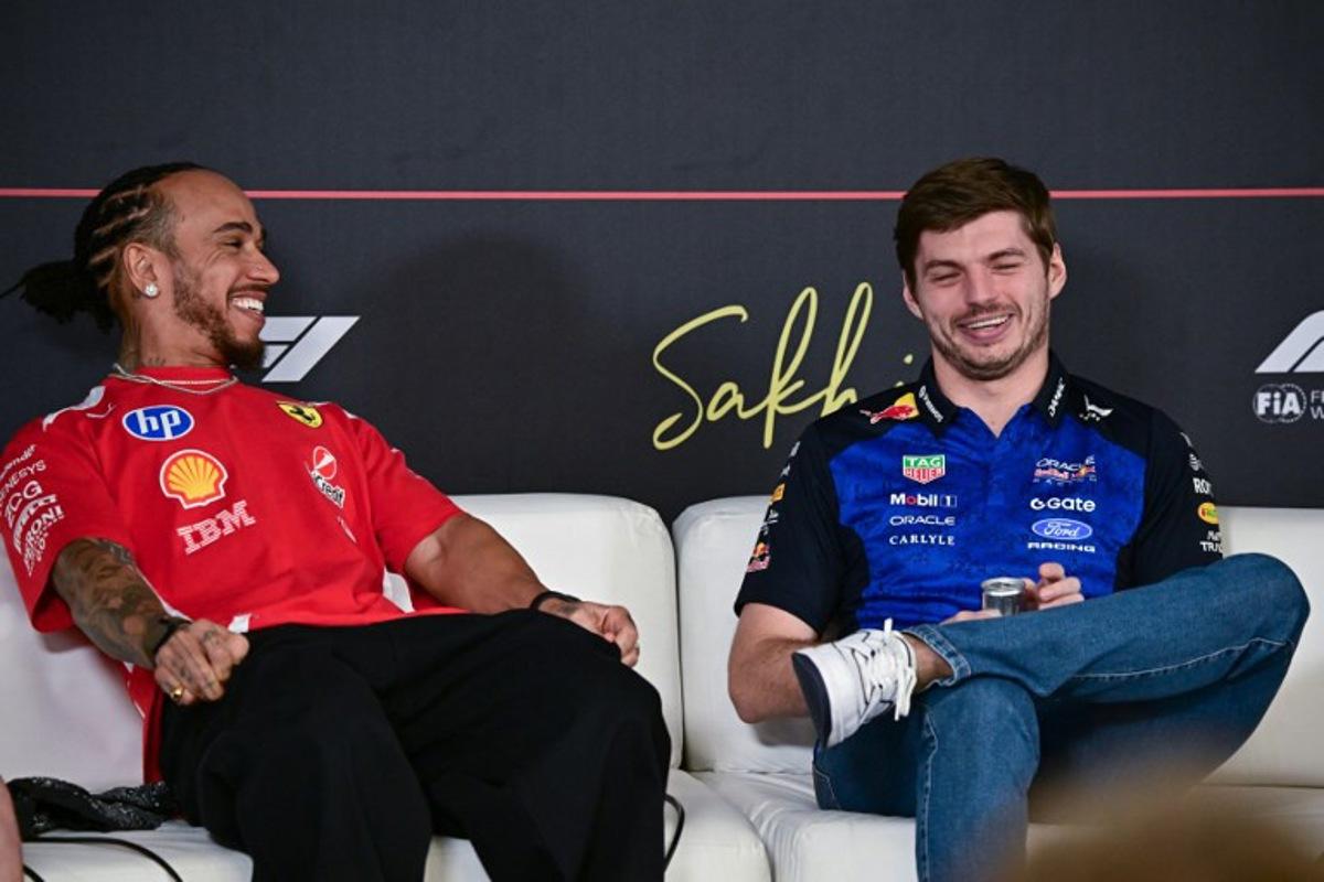 Ferrari's British driver Lewis Hamilton (L) and Red Bull Racing's Dutch driver Max Verstappen attend a press conference on the first day of the second Formula One pre-season test at the Bahrain International Circuit in Sakhir on February 18, 2026.  Giuseppe CACACE / AFP