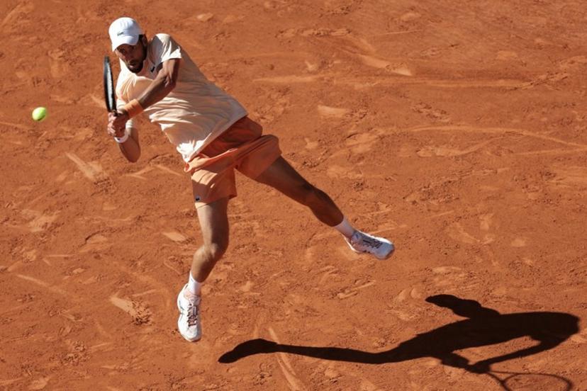 Serbia's Novak Djokovic plays a backhand return to France's Valentin Royer during their men's singles match on day 4 of the French Open tennis tournament on Court Philippe-Chatrier at the Roland-Garros Complex in Paris on May 27, 2026.  Thomas SAMSON / AFP