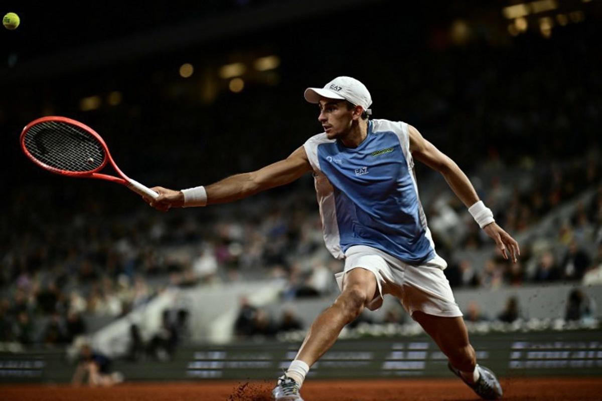Italy's Matteo Arnaldi plays a backhand return to Italy's Matteo Berrettini during their men's quarter final singles match on day 11 of the French Open tennis tournament on Court Philippe-Chatrier at the Roland-Garros Complex in Paris on June 3, 2026.  JULIEN DE ROSA / AFP