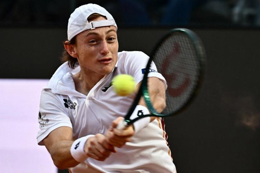 Peru's Ignacio Buse plays a backhand return to Italy's Lorenzo Sonego during their men's singles match of the WTA Rome Open tennis tournament at the Foro Italico in Rome on May 7, 2026.   Filippo MONTEFORTE / AFP