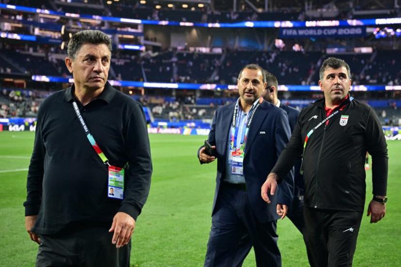 Iran's head coach Amir Ghalenoei (L) walks out the pitch after the 2026 World Cup Group G football match between Iran and New Zealand at Los Angeles Stadium in Inglewood on June 15, 2026.   Frederic J. Brown / AFP