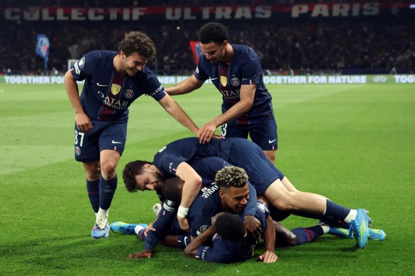 Paris Saint-Germain's French forward #10 Ousmane Dembele (down) celebrates with Paris Saint-Germain's French midfielder #14 Desire Doue, Paris Saint-Germain's Georgian forward #07 Khvicha Kvaratskhelia and Paris Saint-Germain's Portuguese defender #25 Nuno Mendes, Paris Saint-Germain's Portuguese midfielder #87 Joao Neves and Paris Saint-Germain's French midfielder #33 Warren Zaire-Emery after scoring his team fifth goal during the UEFA Champions League semi-final first leg football match between Paris Saint-Germain (PSG) and Bayern Munich at the Parc des Princes in Paris on April 28, 2026.  Alain JOCARD / AFP