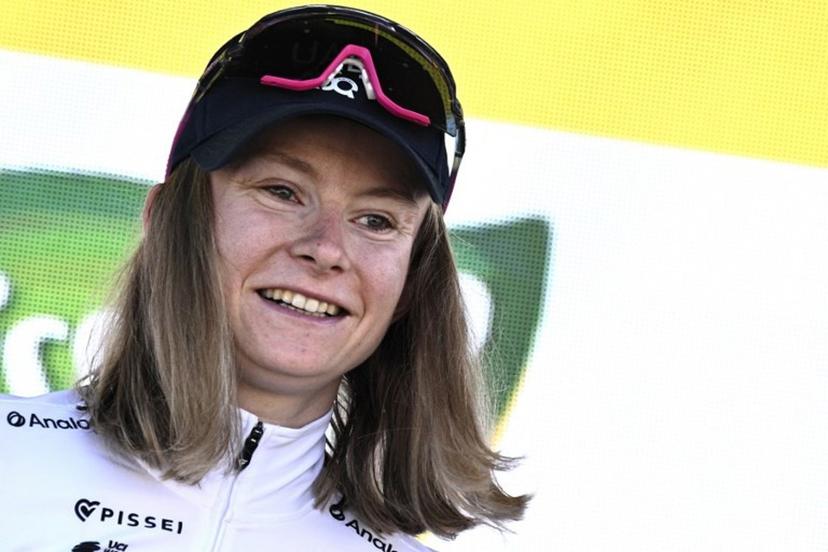 UAE Team ADQ's French rider Maeva Squiban celebrates her combativity award on the podium after winning the 7th stage (out of 9) of the fourth edition of the Women's Tour de France cycling race, 159.7 km from Bourg-en-Bresse to Chambéry, in Chambéry, south-eastern France on August 1, 2025.  JULIEN DE ROSA / AFP