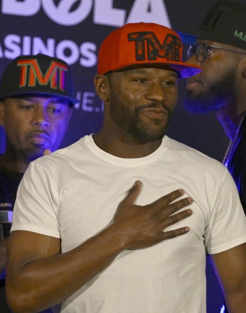 US boxer Floyd Mayweather Jr. gestures during the weighing ceremony for his upcoming exhibition fight against John Gutti III in Mexico City on August 23, 2024. Mayweather Jr. and Gotti III will face each other in an exhibition fight in Mexico on August 24, 2024. ALFREDO ESTRELLA / AFP