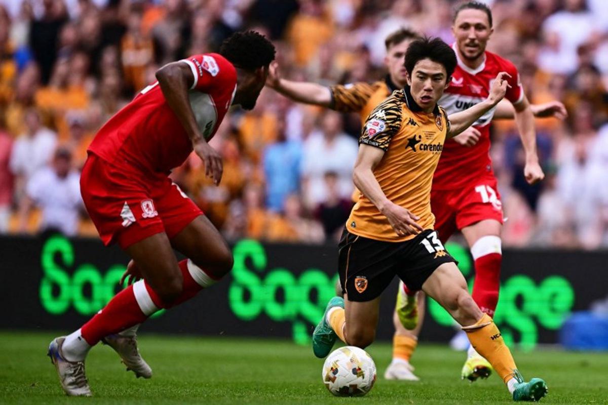 Hull City's Japanese midfielder #13 Yu Hirakawa runs with the ball during the English Championship play-off final football match between Hull City and Middlesbrough at Wembley Stadium in London on May 23, 2026.  Ben STANSALL / AFP
