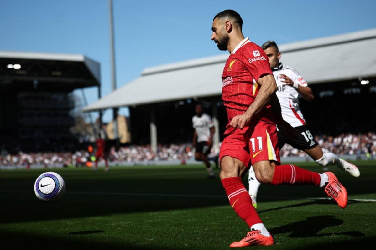 Liverpool's Egyptian striker #11 Mohamed Salah controls the ball during the English Premier League football match between Fulham and Liverpool at Craven Cottage in London on April 6, 2025.  HENRY NICHOLLS / AFP