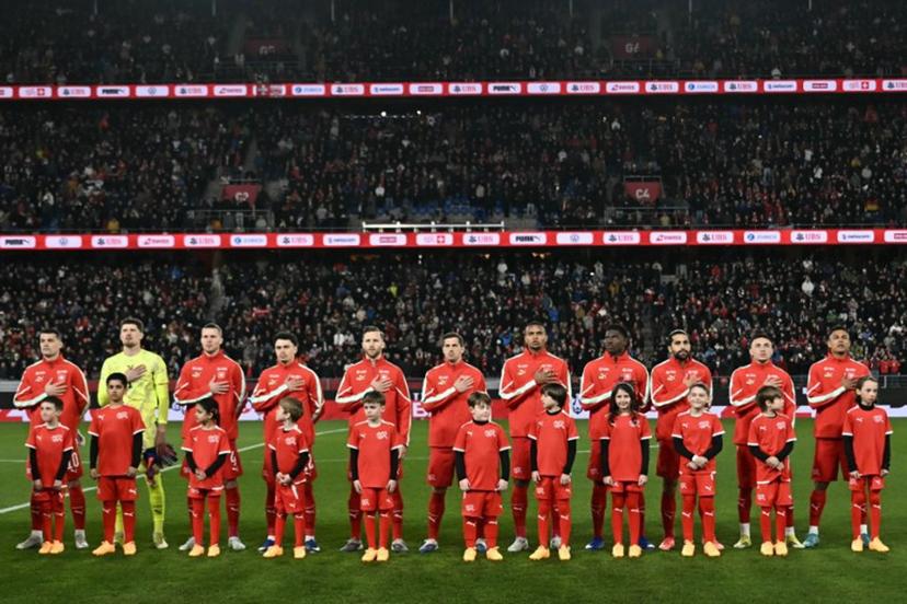 Switzerland's starting squad stands on the pitch for national anthems ahead of the start of the international friendly football match between Switzerland and Germany at St. Jakob-Park in Basel, Switzerland on March 27, 2026.  Fabrice COFFRINI / AFP