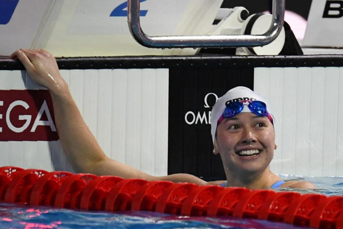Hong Kong's Siobhan Haughey celebrates her win in the Women's 200 meters Freestyle final during the World Aquatics Swimming Championships (25 m) 2024 at Duna Arena in Budapest, on December 15, 2024.  Ferenc ISZA / AFP