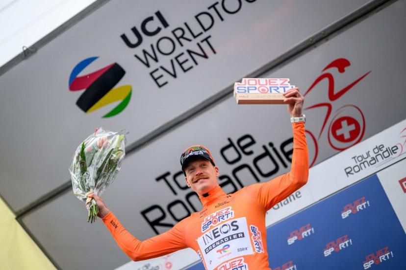 INEOS Grenadiers' French rider Dorian Godon celebrates on the podium after winning the prologue of the Tour of Romandie UCI cycling World tour, a 3.2 km time trial from Villars-sur-Glane to Villars-sur-Glane on April 28, 2026.  Fabrice COFFRINI / AFP