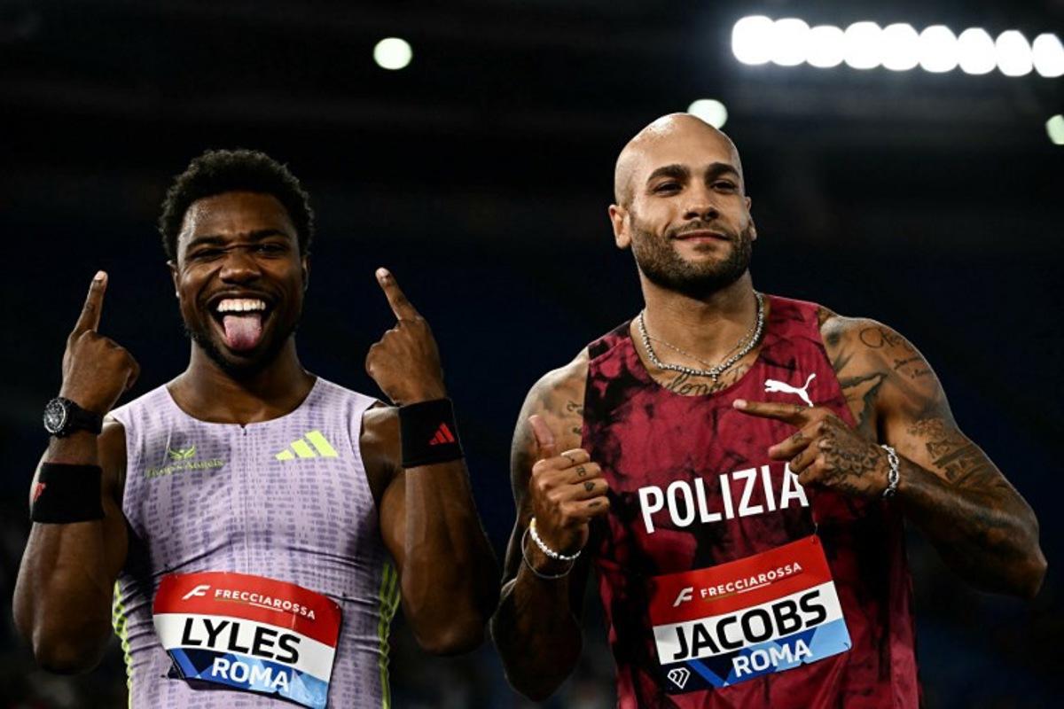 Winner USA's Noah Lyles (L) celebrates next to fifth placed Italy's Marcell Jacobs (R) after competing in the Men's 100m during the IAAF Diamond League athletics meeting, at the Olympic Stadium, in Rome on June 4, 2026.  Filippo MONTEFORTE / AFP