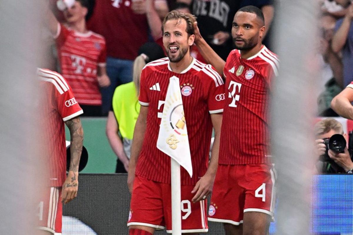 Bayern Munich's English forward #09 Harry Kane celebrates scoring the opening goal with his teammate Bayern Munich's German defender #04 Jonathan Tah during the German Cup (DFB Pokal) final football match FC Bayern Munich v VfB Stuttgart at the Olympic Stadium in Berlin, on May 23, 2026.  Tobias SCHWARZ / AFP