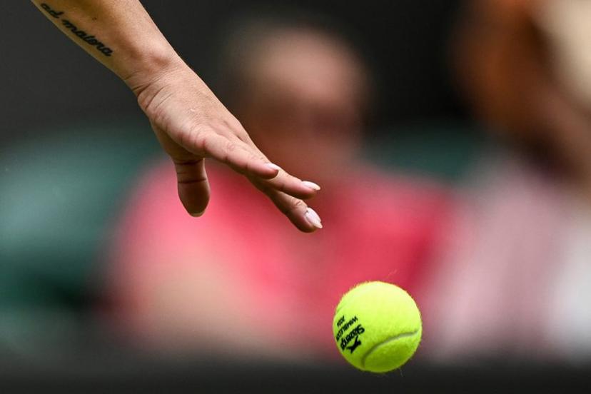 The tatoo of Italy's Martina Trevisan reading "A Maiora" in Latin (which translates as "Towards greater things" in English) is pictured on her arm as she bounces the ball prior to serve against US player Madison Keys during their Women's singles tennis match on the first day of the 2024 Wimbledon Championships at The All England Lawn Tennis and Croquet Club in Wimbledon, southwest London, on July 1, 2024.  Ben Stansall / AFP