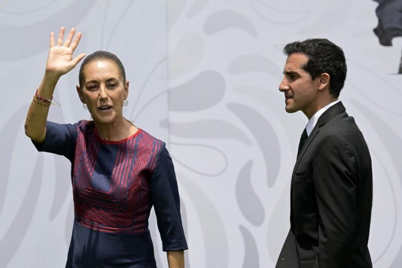 Mexico's President Claudia Sheinbaum waves next to Mexico's National Commission for Physical Culture and Sport (CONADE) director Rommel Pacheco, during the flag presentation ceremony for the Mexican national football team ahead of the FIFA 2026 World Cup at the Centro de Alto Rendimiento in Mexico City on June 8, 2026.  Alfredo ESTRELLA / AFP