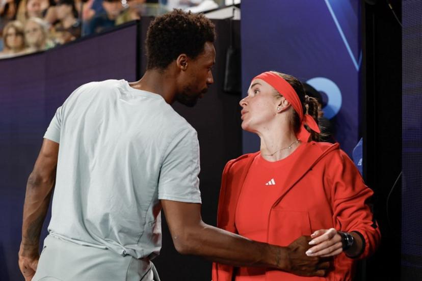 France's Gael Monfils (L) embraces his wife Ukraine's Elina Svitolina following her victory against Italy's Jasmine Paolini in their women's singles match on day seven of the Australian Open tennis tournament in Melbourne on January 18, 2025.  Martin KEEP / AFP
