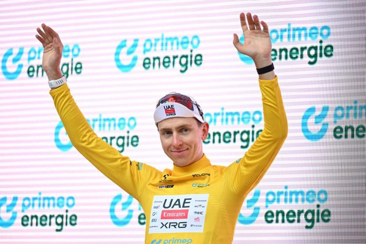 UAE Team Emirates-XRG's Slovenian rider Tadej Pogacar wearing the overall leader yellow jersey celebrates during the podium ceremony of the third stage, 157,4 km from Bad Ragaz to Bad Ragaz, of the Men's Tour of Switzerland (Tour de Suisse) cycling race in Bad Ragaz on June 19, 2026.  HAROLD CUNNINGHAM / AFP