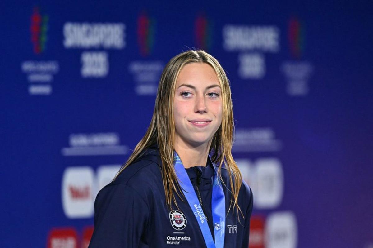 Gold medallist US' swimmer Gretchen Walsh celebrates on the podium of the women's 50m butterfly swimming event during the 2025 World Aquatics Championships in Singapore on August 2, 2025.  MANAN VATSYAYANA / AFP