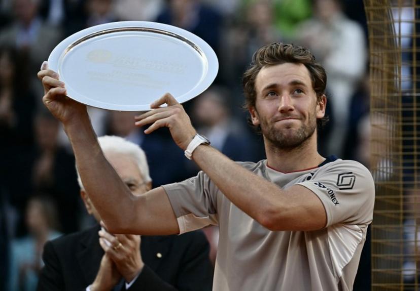 Norway's Casper Ruud holds a trophy after the match against Italy's Jannik Sinner in their men's final of the ATP Rome Open tennis tournament at the Foro Italico in Rome on May 17, 2026.   Filippo MONTEFORTE / AFP