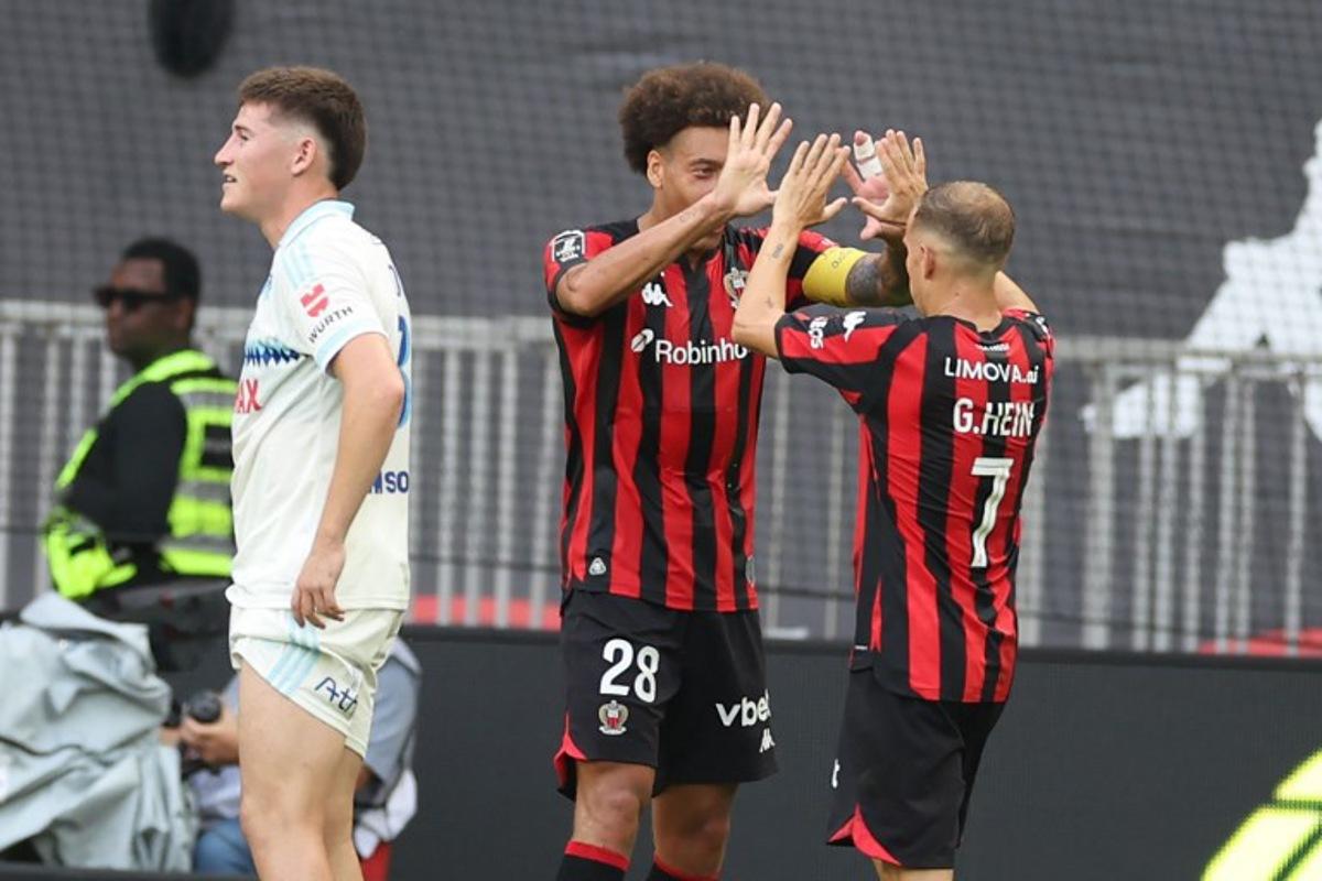 Nice's French forward #07 Gauthier Hein (R) celebrates with Nice's Belgian midfielder #28 Axel Witsel (L) after scoring a goal during the French L1 football match between OGC Nice and RC Strasbourg Alsace at the Allianz Riviera Stadium in Nice on October 11, 2026.  Valery HACHE / AFP