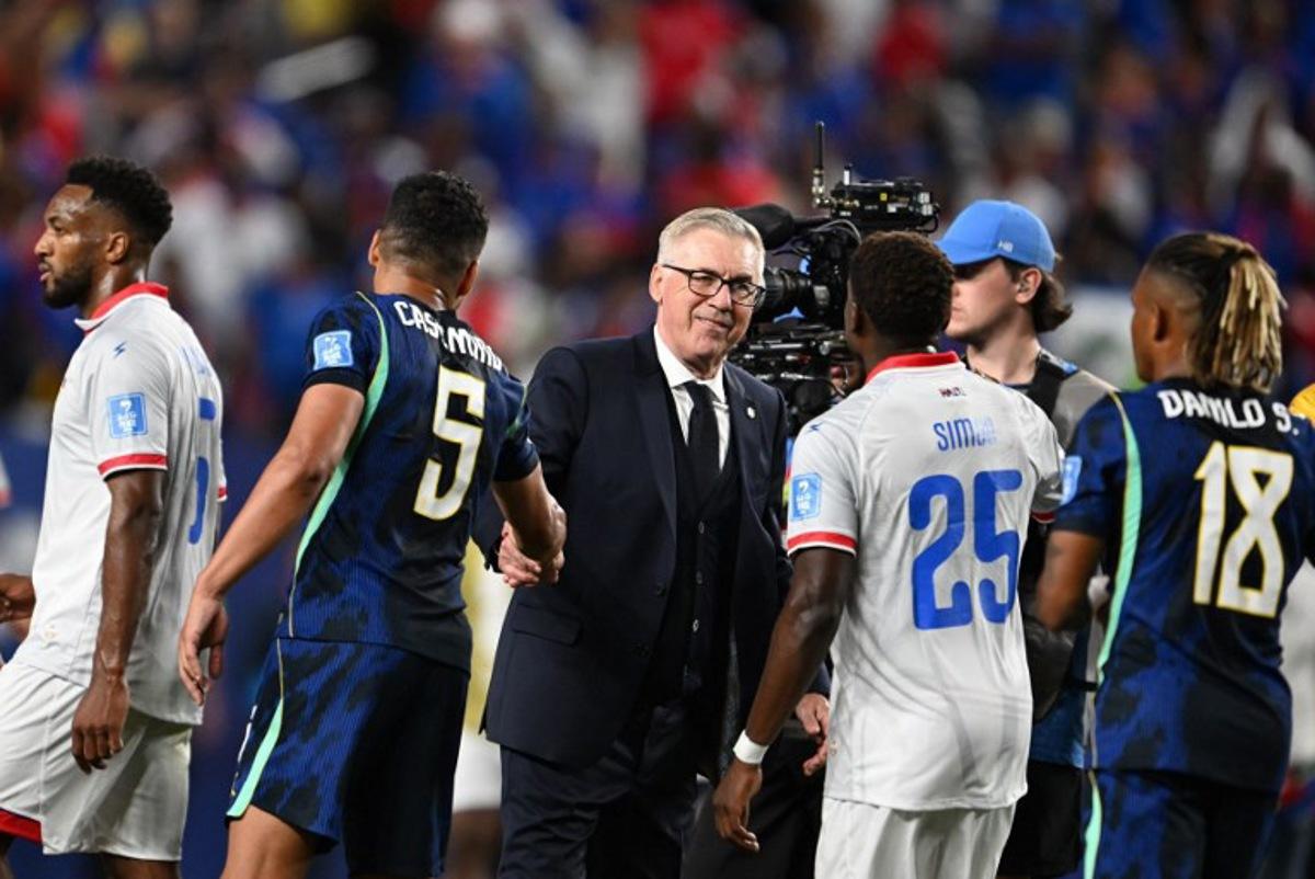 Brazil's Italian head coach Carlo Ancelotti shakes hands with midfielder #05 Casemiro past Haiti's midfielder #25 Dominique Simon after the 2026 World Cup Group C football match between Brazil and Haiti at the Philadelphia Stadium in Philadelphia on June 19, 2026.   ROBERTO SCHMIDT / AFP