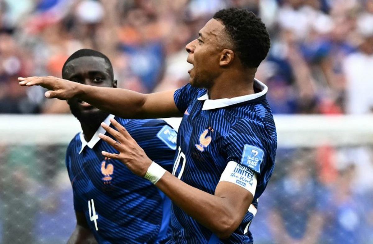 France's forward #10 Kylian Mbappe (R) celebrates scoring his team's first goal during the 2026 World Cup Group I football match between France and Iraq at the Philadelphia Stadium in Philadelphia on June 22, 2026.   Jewel SAMAD / AFP