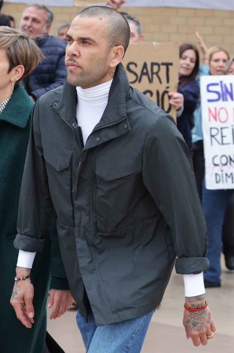 Convicted rapist and former Brazil international football player Dani Alves leaves on provisional release after posting one-million-euro bail, at Brians 2 prison in San Esteban Sasroviras, near Barcelona, on March 25, 2024. Convicted rapist and former Brazil international Dani Alves left a jail in Barcelona on March 25, 2024 after posting the one-million-euro bail set by a Barcelona court to ensure his release pending appeal. Ex-Brazil star has been sentenced to 4.5 years in jail for rape on February 22, 2024. LLUIS GENE / AFP