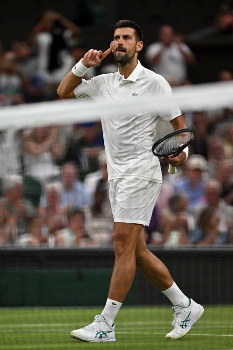 Serbia's Novak Djokovic reacts as he plays against China's Yibing Wu during their men's singles first round tennis match on the first day of the 2026 Wimbledon Championships at The All England Lawn Tennis and Croquet Club in Wimbledon, southwest London, on June 29, 2026.  Glyn KIRK / AFP