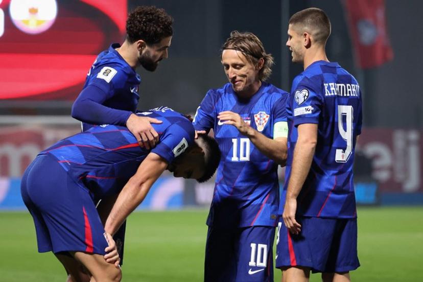 Croatia's defender #05 Martin Erlic (C) is congratulated by Croatia's defender #04 Josko Gvardiol (L, Croatia's midfielder #10 Luka Modric (2ndR) and Croatia's forward #09 Andrej Kramaric (R) after scoring his team's third goal during the FIFA World Cup 2026 Group L European qualification football match between Croatia and Gibraltar at the Maksimir Stadium in Zagreb, on October 12, 2025.  STRINGER / AFP