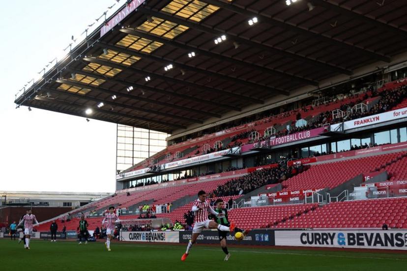 Players compete for the ball against a view of empty seats during the English FA Cup third round football match between Stoke City and Brighton and Hove Albion at the bet365 Stadium, in Stoke on Trent, central England, on January 6, 2024.  Darren Staples / AFP