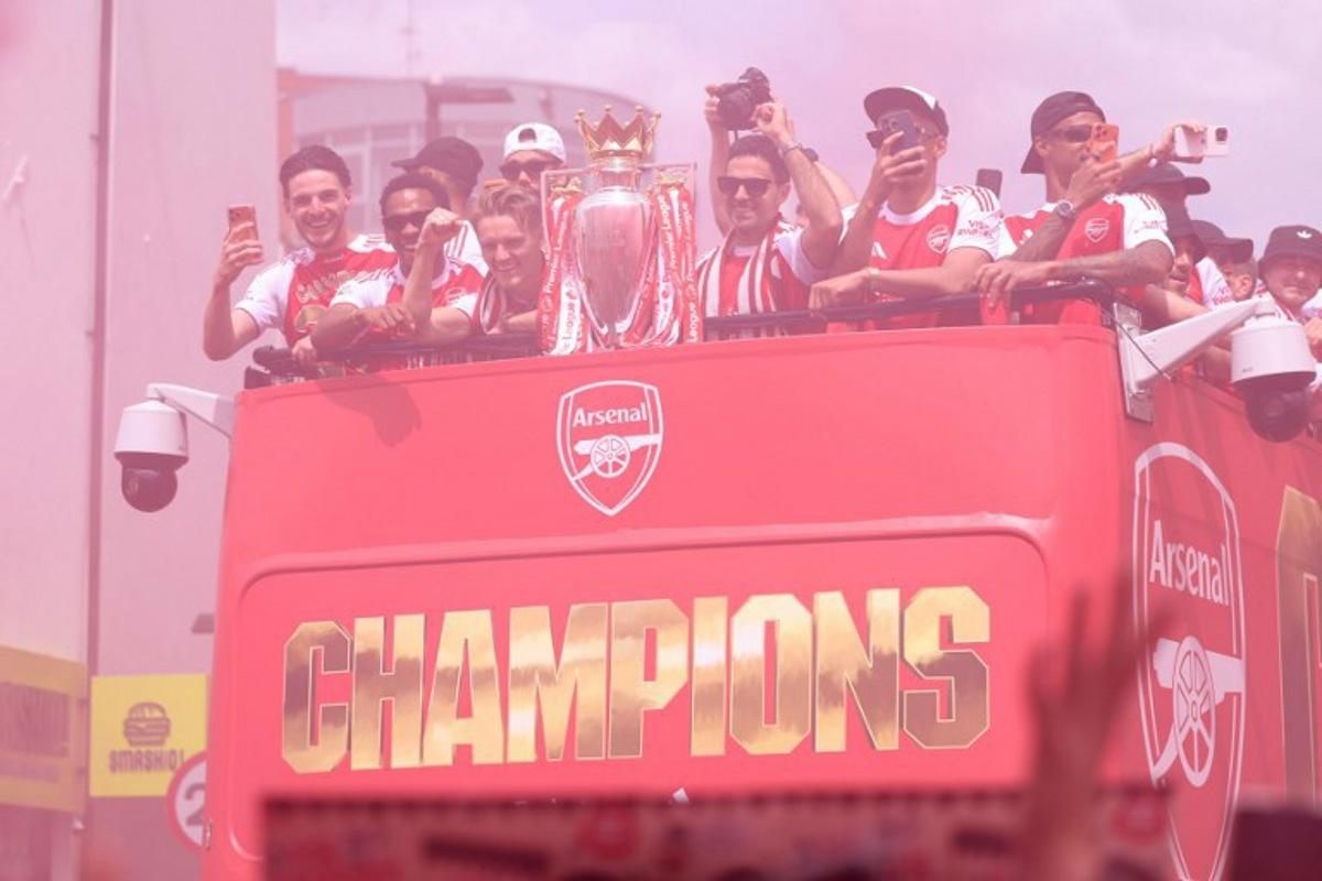 (L-R) Arsenal's English midfielder #41 Declan Rice, Arsenal's Dutch defender #12 Jurrien Timber, Arsenal's Norwegian midfielder #08 Martin Odegaard, Arsenal's Spanish manager Mikel Arteta, Arsenal's French defender #02 William Saliba and Arsenal's Brazilian defender #06 Gabriel Magalhaes celebrate with the Premier League trophy during a victory parade around the streets near to the Emirates Stadium, in London, on May 31, 2026. It is the first Premier League title for the North London team since the 2003-04 season. Toby Shepheard / AFP