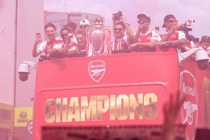 (L-R) Arsenal's English midfielder #41 Declan Rice, Arsenal's Dutch defender #12 Jurrien Timber, Arsenal's Norwegian midfielder #08 Martin Odegaard, Arsenal's Spanish manager Mikel Arteta, Arsenal's French defender #02 William Saliba and Arsenal's Brazilian defender #06 Gabriel Magalhaes celebrate with the Premier League trophy during a victory parade around the streets near to the Emirates Stadium, in London, on May 31, 2026. It is the first Premier League title for the North London team since the 2003-04 season. Toby Shepheard / AFP