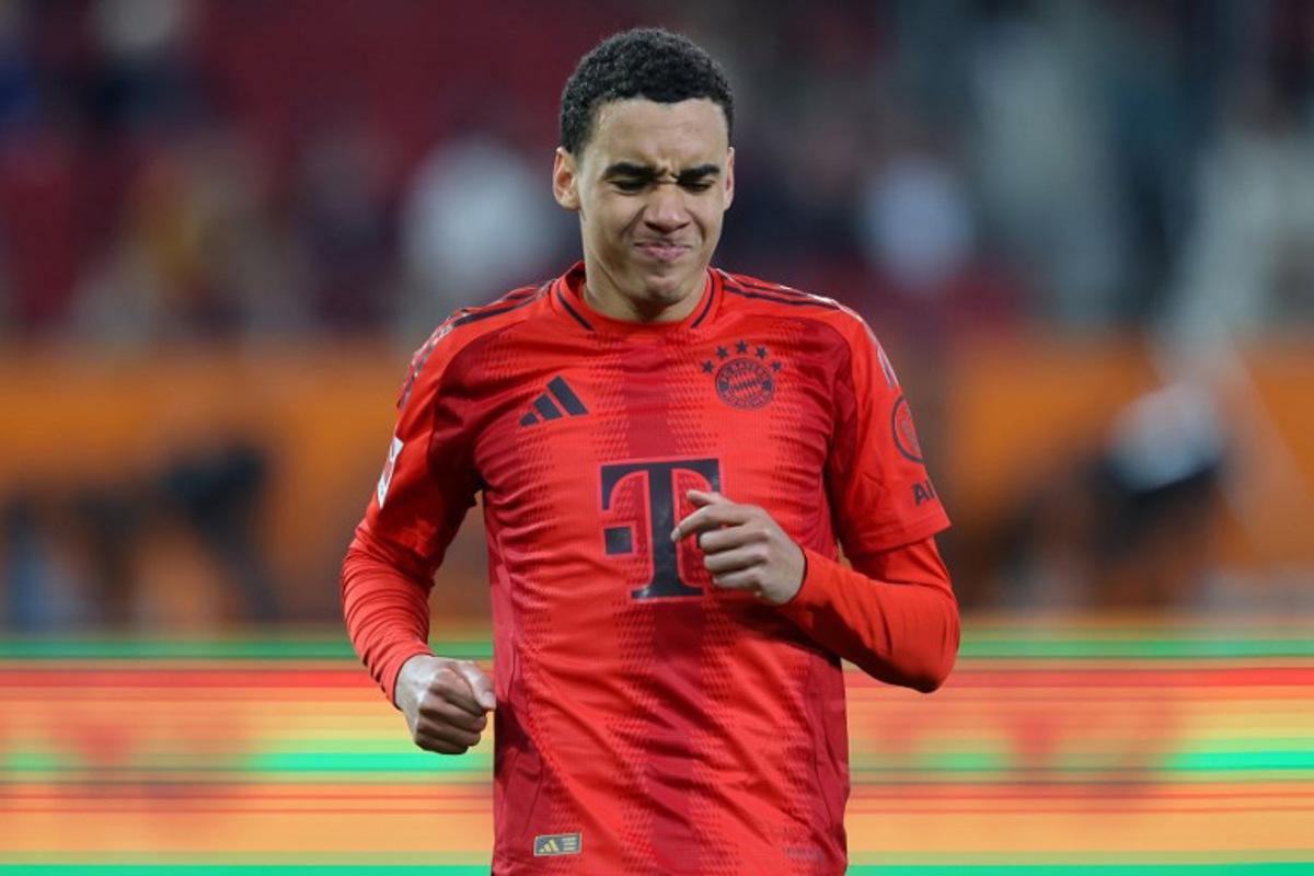 Bayern Munich's German midfielder #42 Jamal Musiala reacts after sustaining an injury during the German first division Bundesliga football match between FC Augsburg and FC Bayern Munich in Augsburg, southern Germany, on April 4, 2025.  Alexandra BEIER / AFP