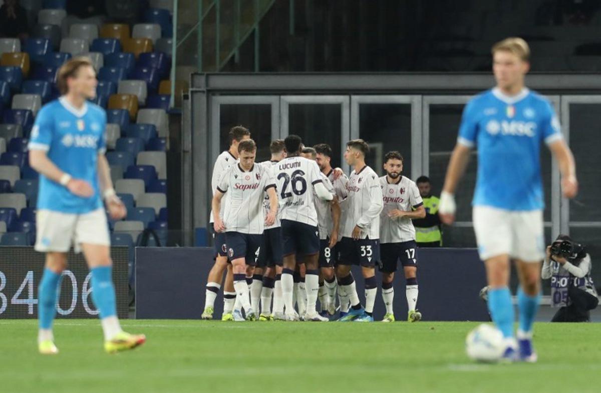 Bologna's Italian forward #7 Riccardo Orsolini (hidden) celebrates with teammates after scoring a goal on penalty during the Italian Serie A football match between SSC Napoli and Bologna FC 1909 at the Diego Armando Maradona Stadium in Naples on May 11, 2026.  CARLO HERMANN / AFP