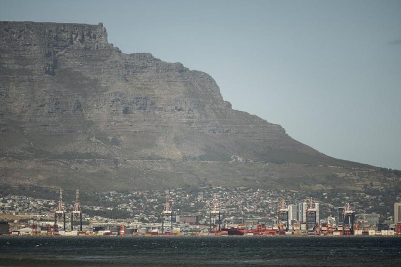 A general view of Table Mountain and the Cape Town City bowl is seen on December 18, 2025. Nestled between spectacular mountains and the Atlantic Ocean, Cape Town has emerged as a growing tourism destination, topping in 2025 the Telegraph and Time Out magazine's rankings of best cities in the world.  Activists say the drive to profit from tourism accommodation is pricing locals out of coveted neighbourhoods, including areas near District Six -- a site long associated with the apartheid-era removals that displaced non-white communities to remote, underdeveloped townships. GIANLUIGI GUERCIA / AFP