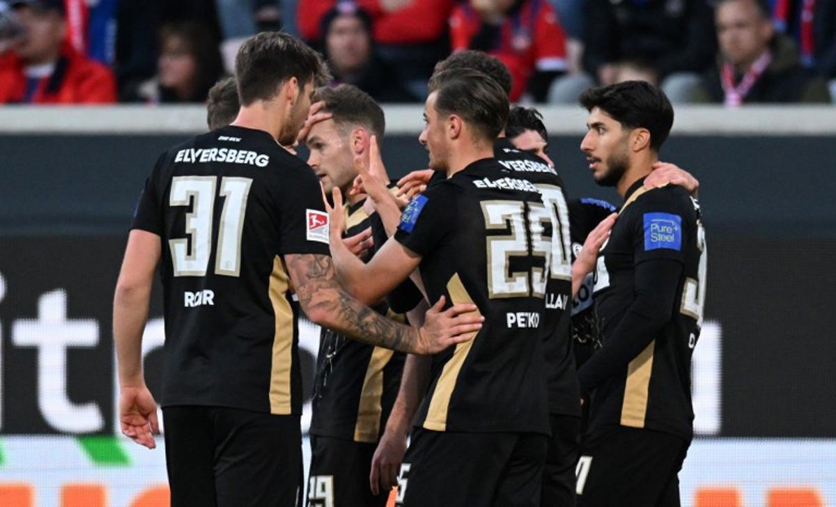 Elversberg's German midfielder #25 Lukas Petkov (R) celebrates with teammates scoring the opening goal during the German Bundesliga relegation first-leg football match  between FC Heidenheim and SV Elversberg in Heidenheim on May 22, 2025.  THOMAS KIENZLE / AFP