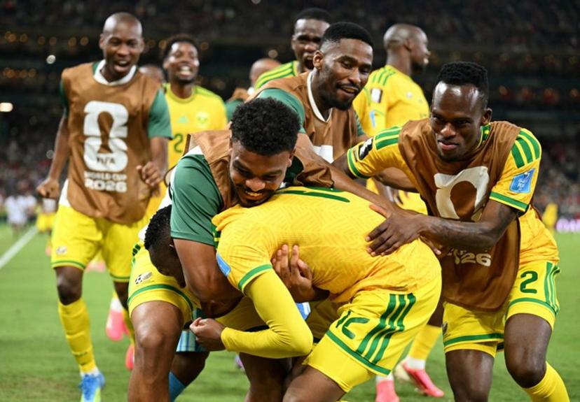 South Africa's forward #12 Thapelo Maseko is hugged by teammates while celebrating scoring his team's first goal during the 2026 World Cup Group A football match between South Africa and South Korea at the Monterrey Stadium in Guadalupe, Mexico, on June 24, 2026.   YURI CORTEZ / AFP